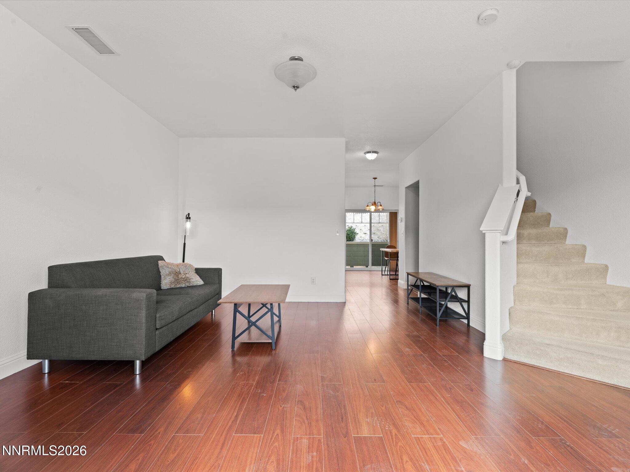 4795 Ciarra Kennedy Lane Reno, NV 89503 - Photo 11 of 37 a living room with furniture and a wooden floor