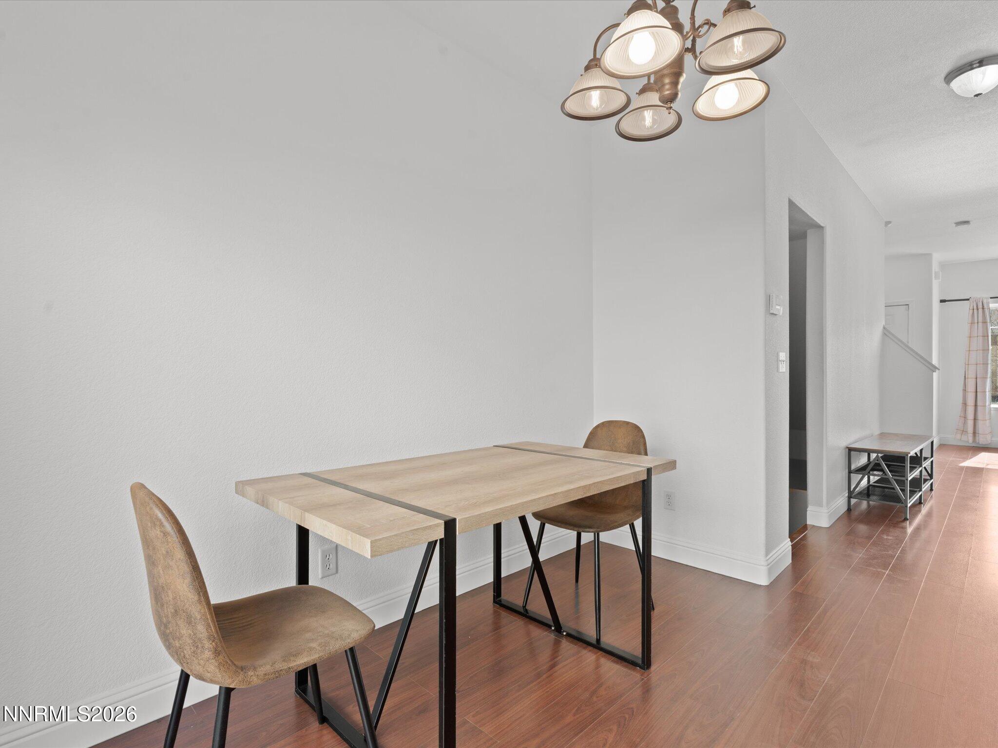 4795 Ciarra Kennedy Lane Reno, NV 89503 - Photo 14 of 37 a view of a dining room with furniture and wooden floor