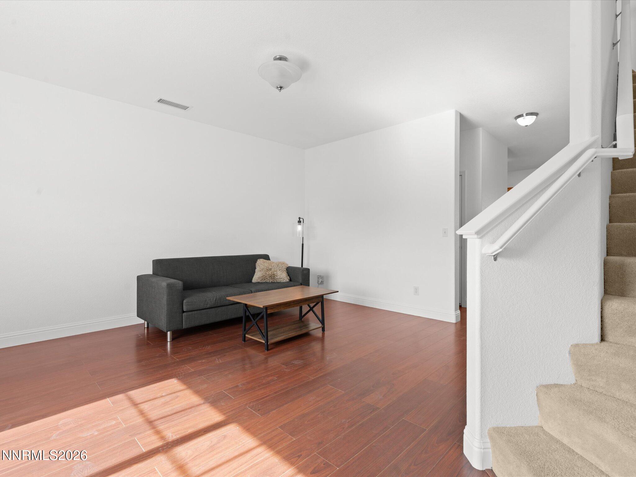 4795 Ciarra Kennedy Lane Reno, NV 89503 - Photo 15 of 37 a living room with furniture and a wooden floor
