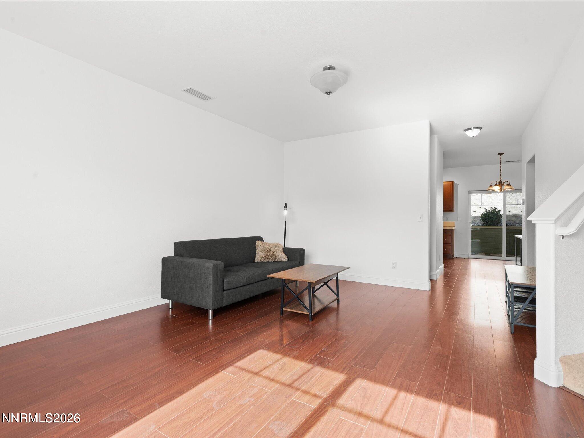 4795 Ciarra Kennedy Lane Reno, NV 89503 - Photo 17 of 37 a living room with furniture and a wooden floor