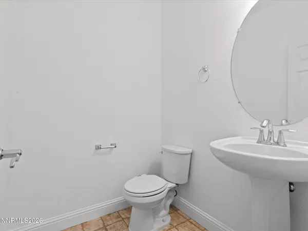 a bathroom with a sink toilet and a mirror