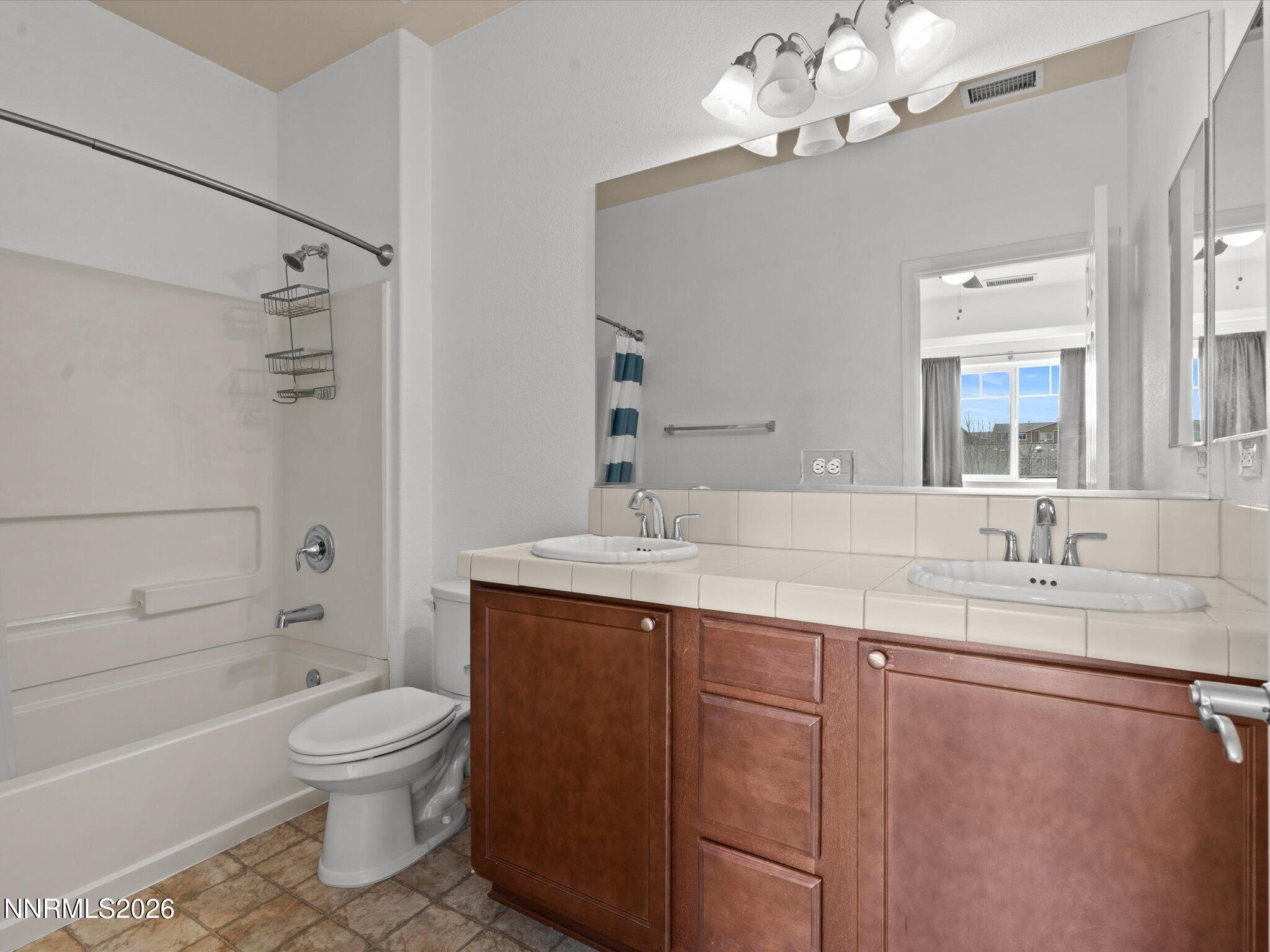 4795 Ciarra Kennedy Lane Reno, NV 89503 - Photo 28 of 37 a bathroom with a toilet a sink and a bathtub