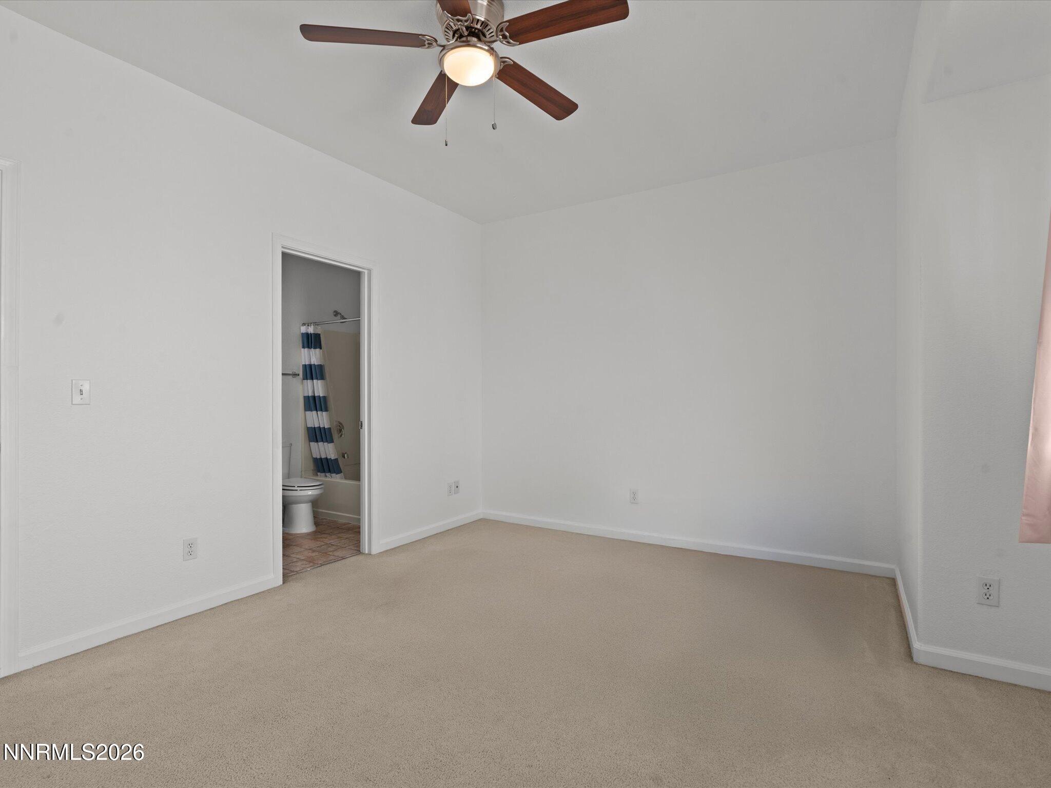 4795 Ciarra Kennedy Lane Reno, NV 89503 - Photo 30 of 37 an empty room with a ceiling fan and window