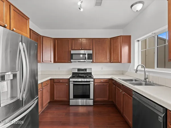 a kitchen with a sink stove and refrigerator