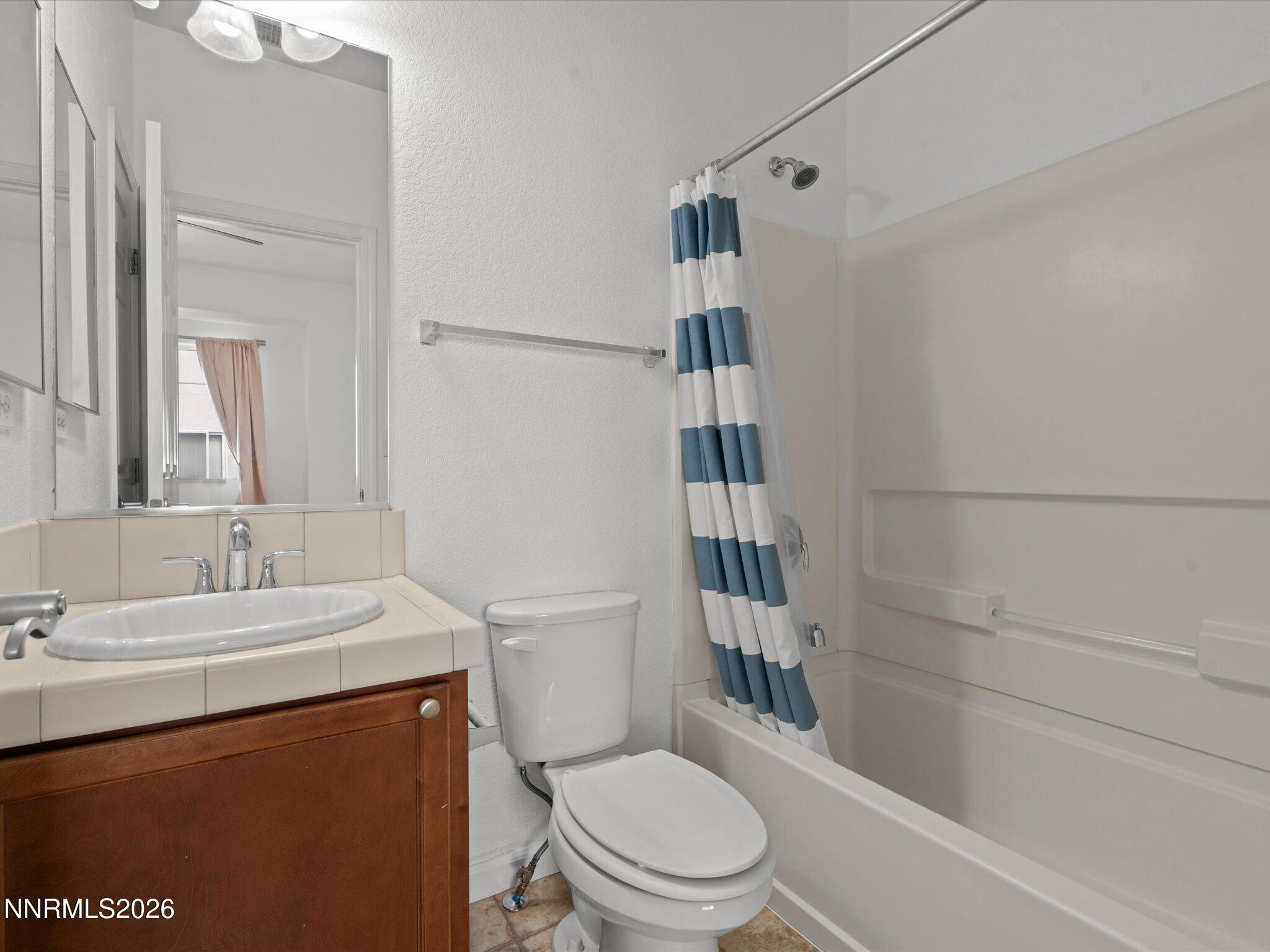 4795 Ciarra Kennedy Lane Reno, NV 89503 - Photo 31 of 37 a bathroom with a sink a toilet and shower