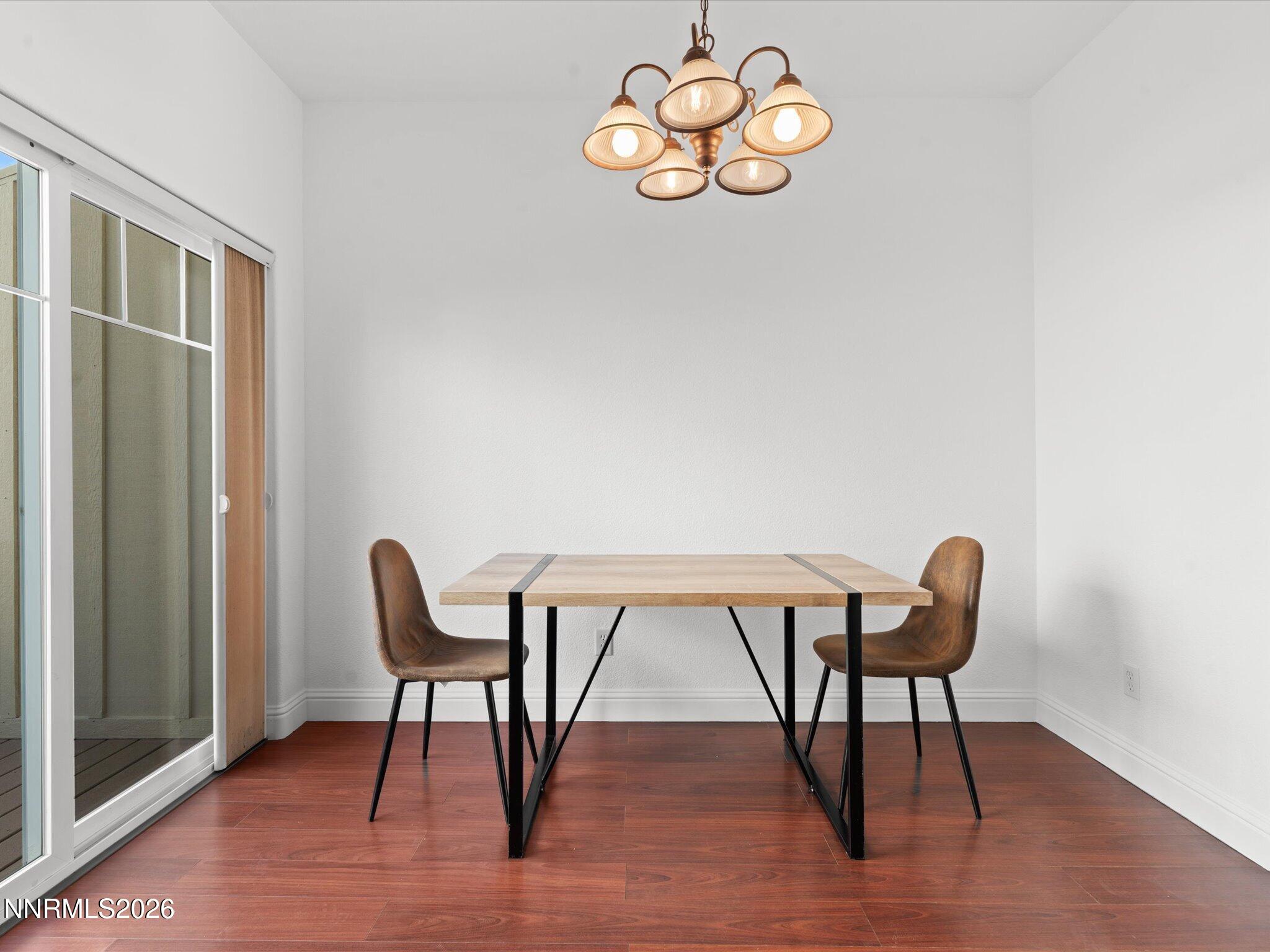 4795 Ciarra Kennedy Lane Reno, NV 89503 - Photo 5 of 37 a view of a dining room with furniture wooden floor and a chandelier