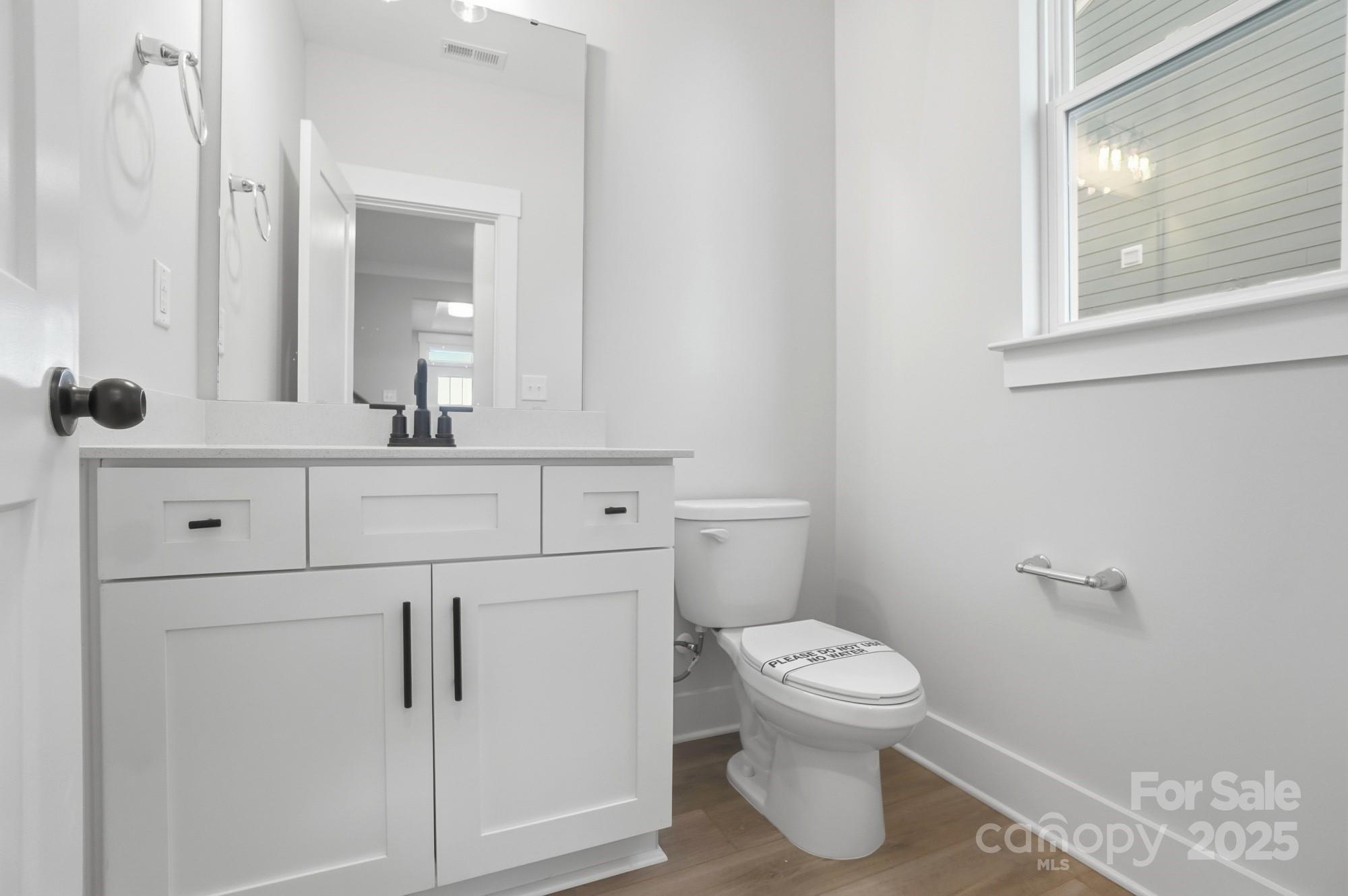123 Viburnum Road Waxhaw, NC 28173 - Photo 11 of 28 a bathroom with a toilet a sink and a mirror