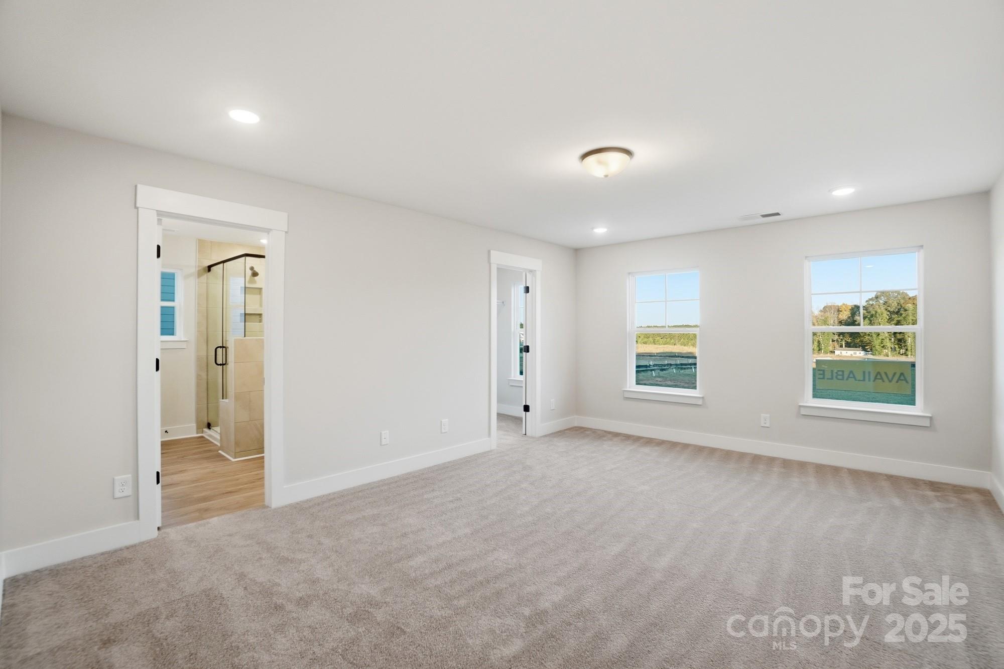 123 Viburnum Road Waxhaw, NC 28173 - Photo 15 of 28 an empty room with windows and closet