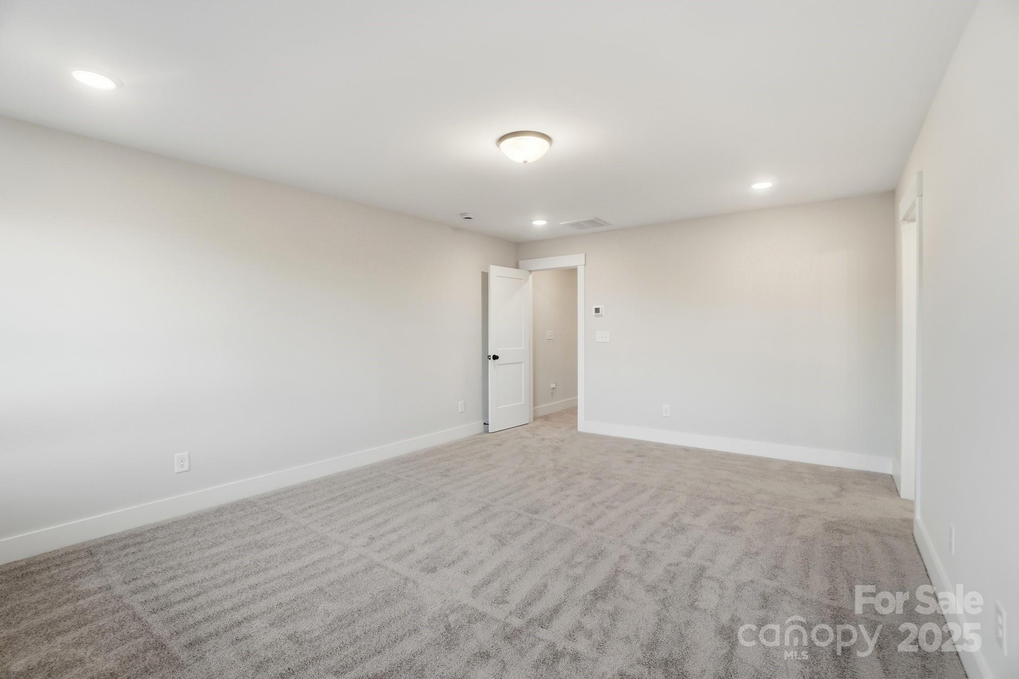 123 Viburnum Road Waxhaw, NC 28173 - Photo 16 of 28 an empty room with wooden floor and windows