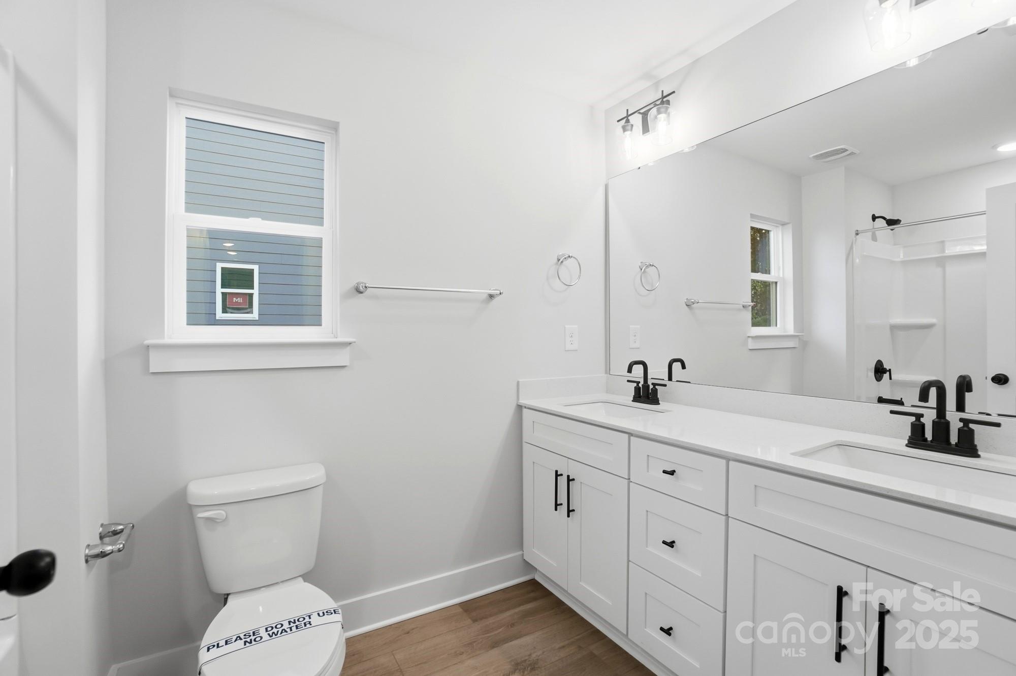 123 Viburnum Road Waxhaw, NC 28173 - Photo 22 of 28 a bathroom with a double vanity sink toilet and a mirror