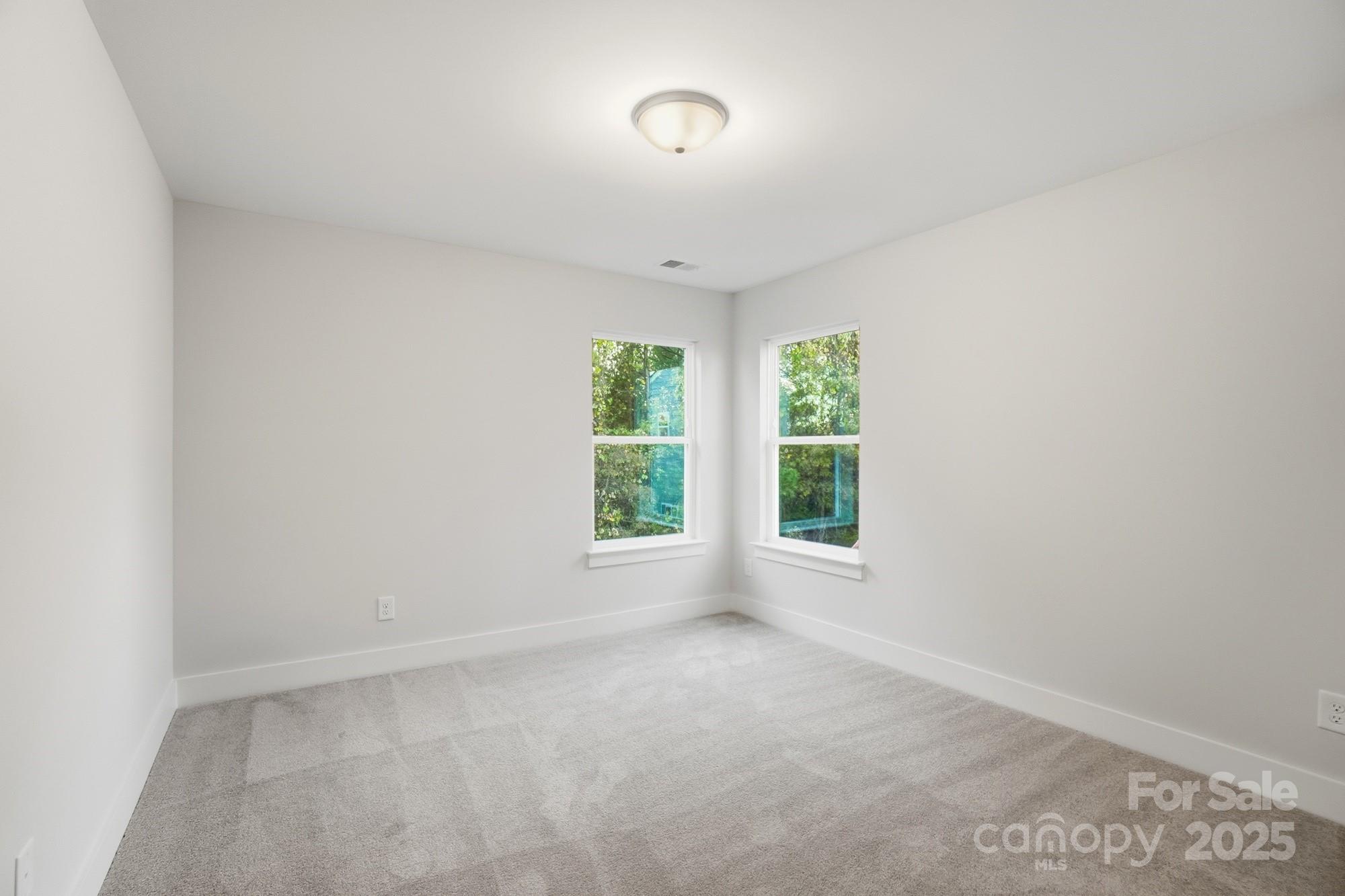 123 Viburnum Road Waxhaw, NC 28173 - Photo 23 of 28 an empty room with windows and entrance