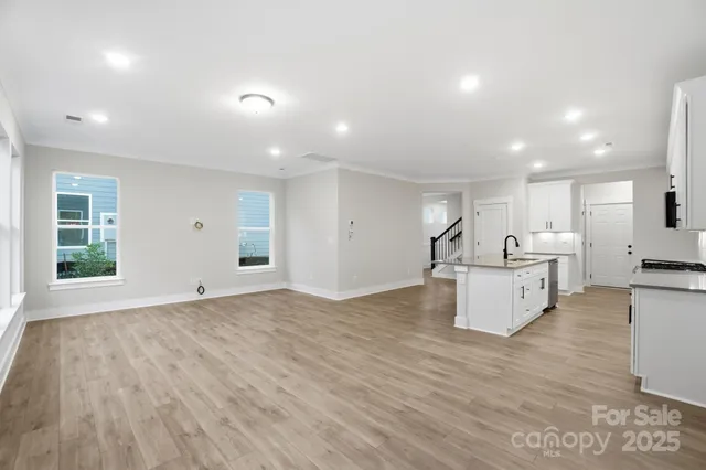 a view of kitchen with sink and refrigerator