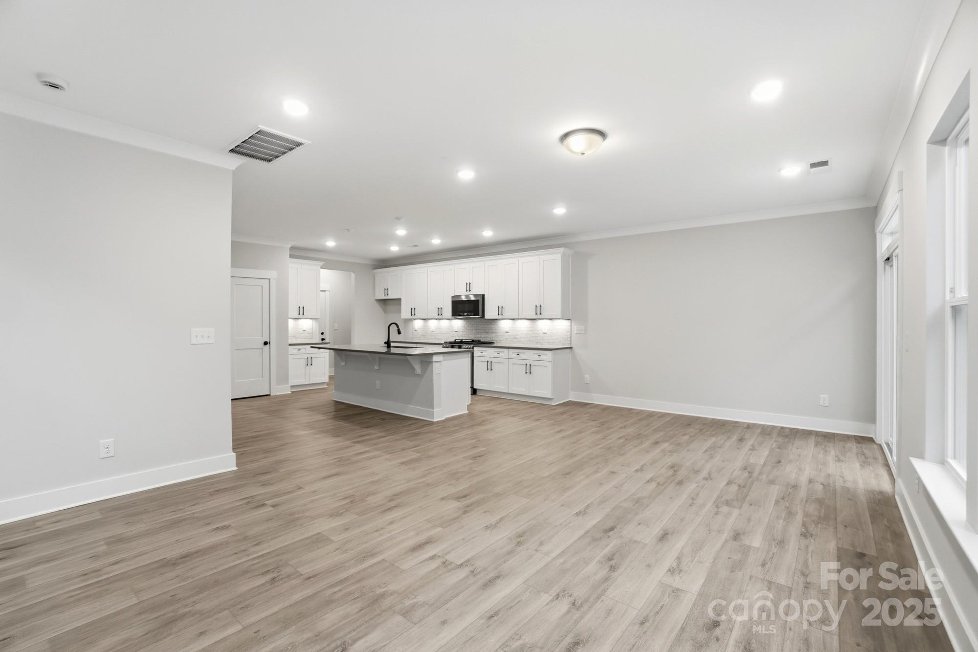 123 Viburnum Road Waxhaw, NC 28173 - Photo 10 of 28 a view of kitchen with wooden floor