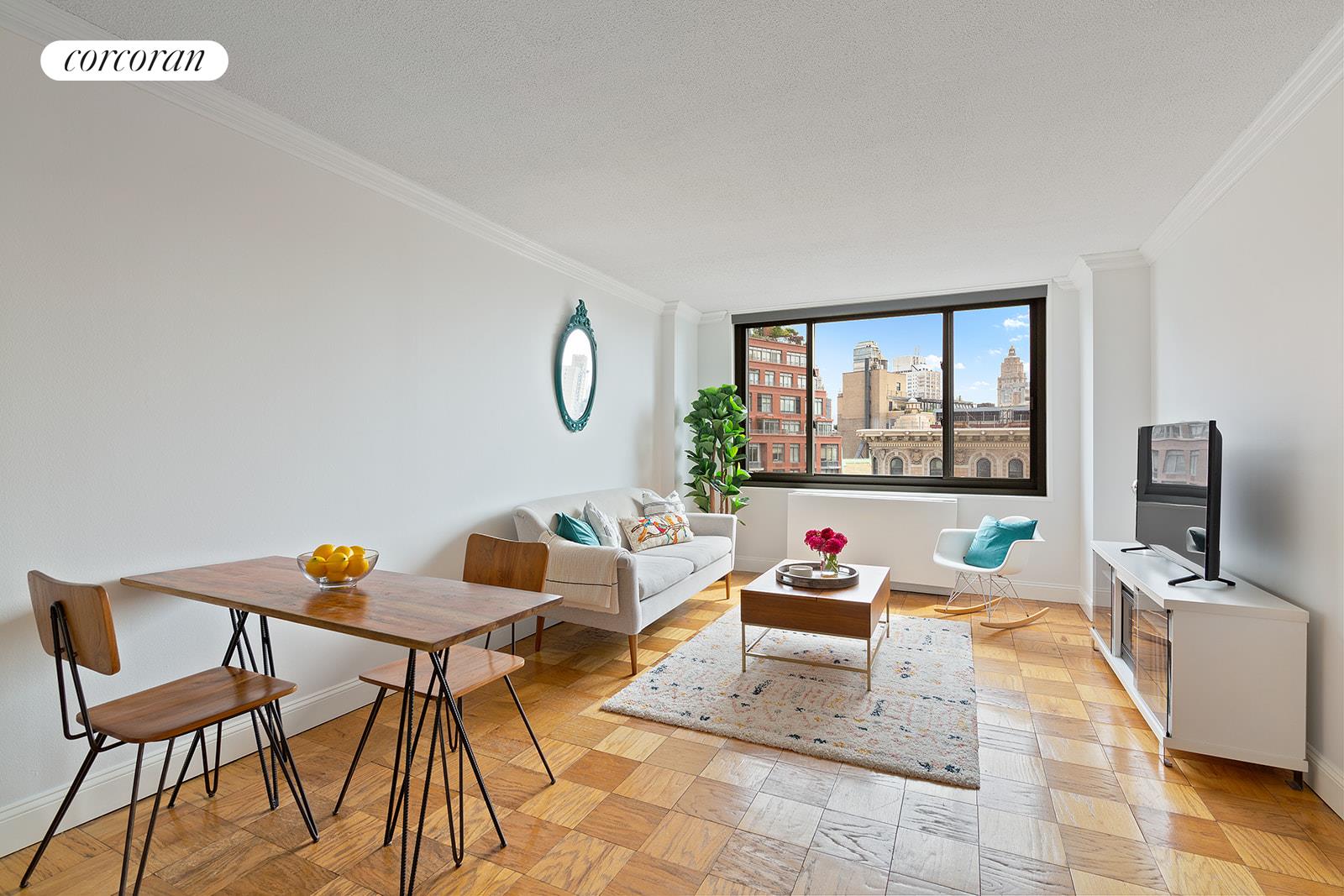 2025 Broadway, Unit 17F Manhattan, NY 10023 - Photo 10 of 15 a living room with furniture and a flat screen tv