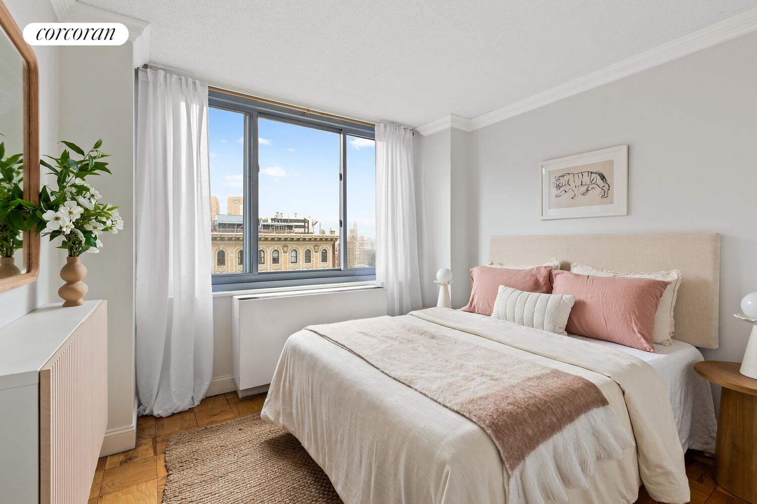 2025 Broadway, Unit 17F Manhattan, NY 10023 - Photo 4 of 15 a bedroom with a large bed and a window