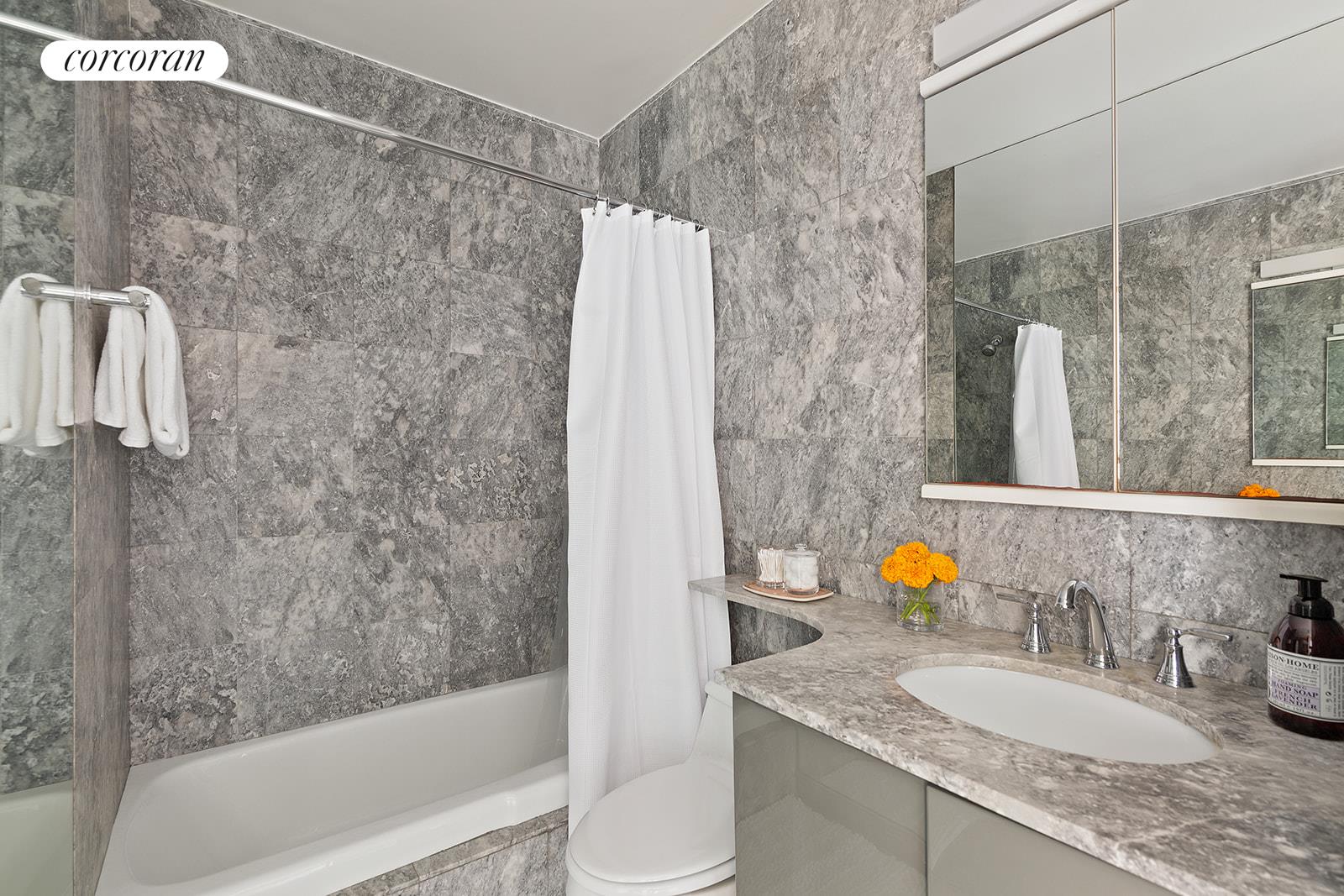 2025 Broadway, Unit 17F Manhattan, NY 10023 - Photo 7 of 15 a bathroom with a granite countertop sink and a mirror