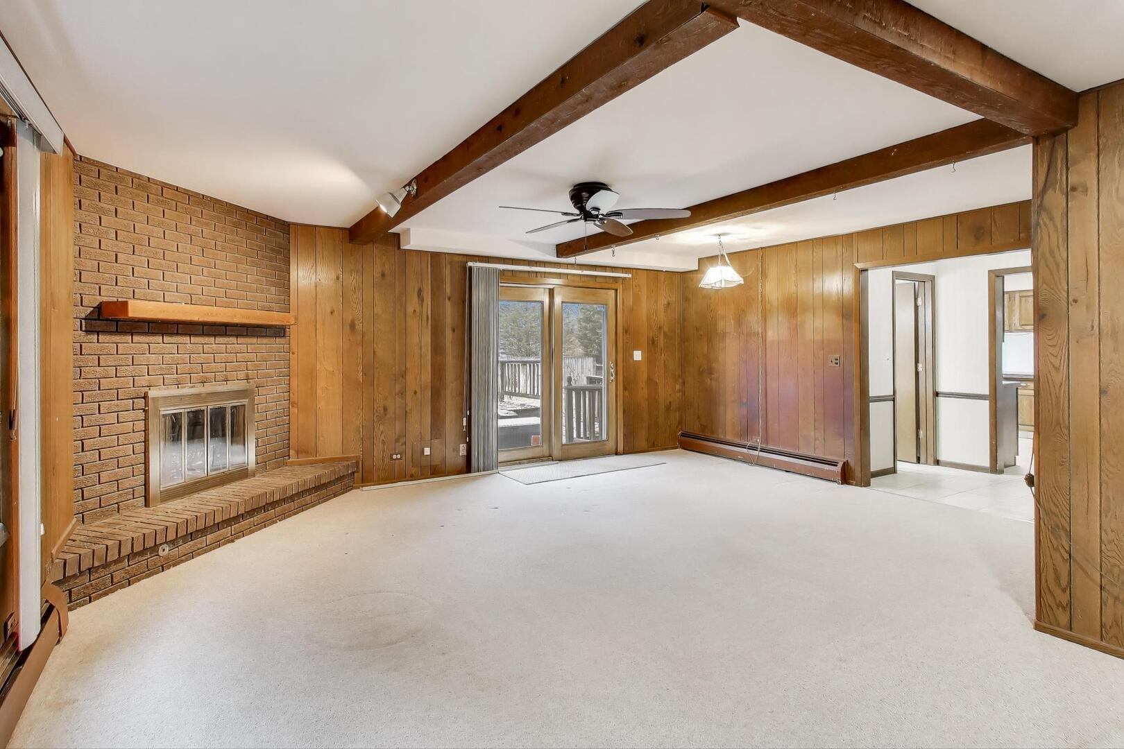 1040 South Linneman Road Mount Prospect, IL 60056 - Photo 12 of 39 a view of an empty room with a fireplace and a window