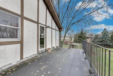 a view of a house with a trees from a corridor