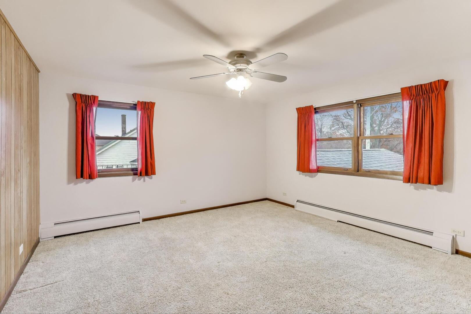 1040 South Linneman Road Mount Prospect, IL 60056 - Photo 23 of 39 an empty room with windows and fan