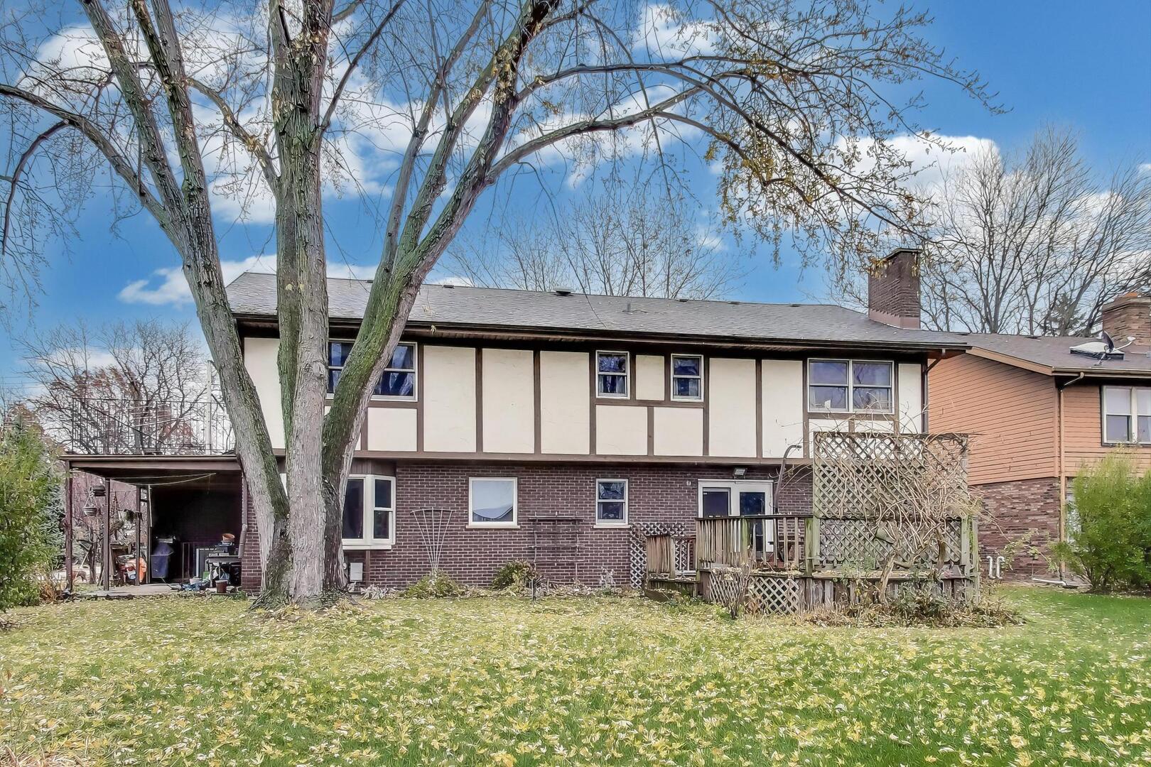 1040 South Linneman Road Mount Prospect, IL 60056 - Photo 32 of 39 a view of a yard in front of a house with large tree