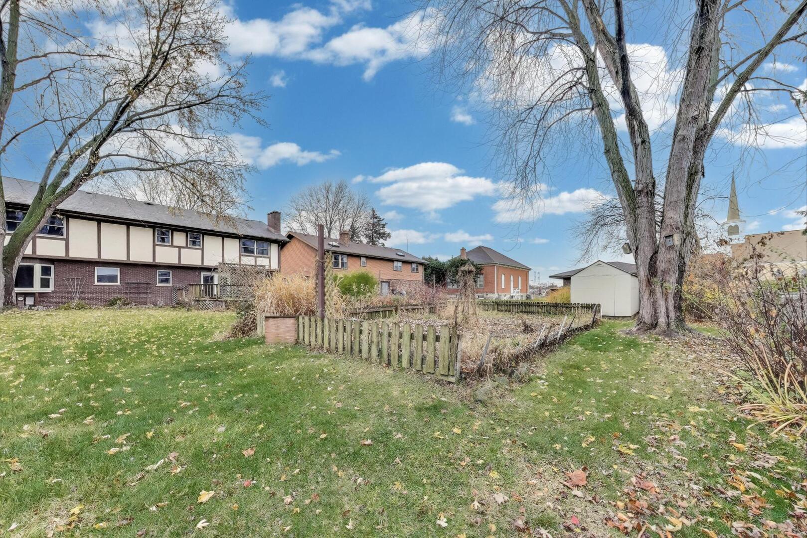1040 South Linneman Road Mount Prospect, IL 60056 - Photo 34 of 39 a view of a house with a yard and a large tree