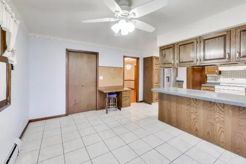 a view of an empty room with window and cabinet