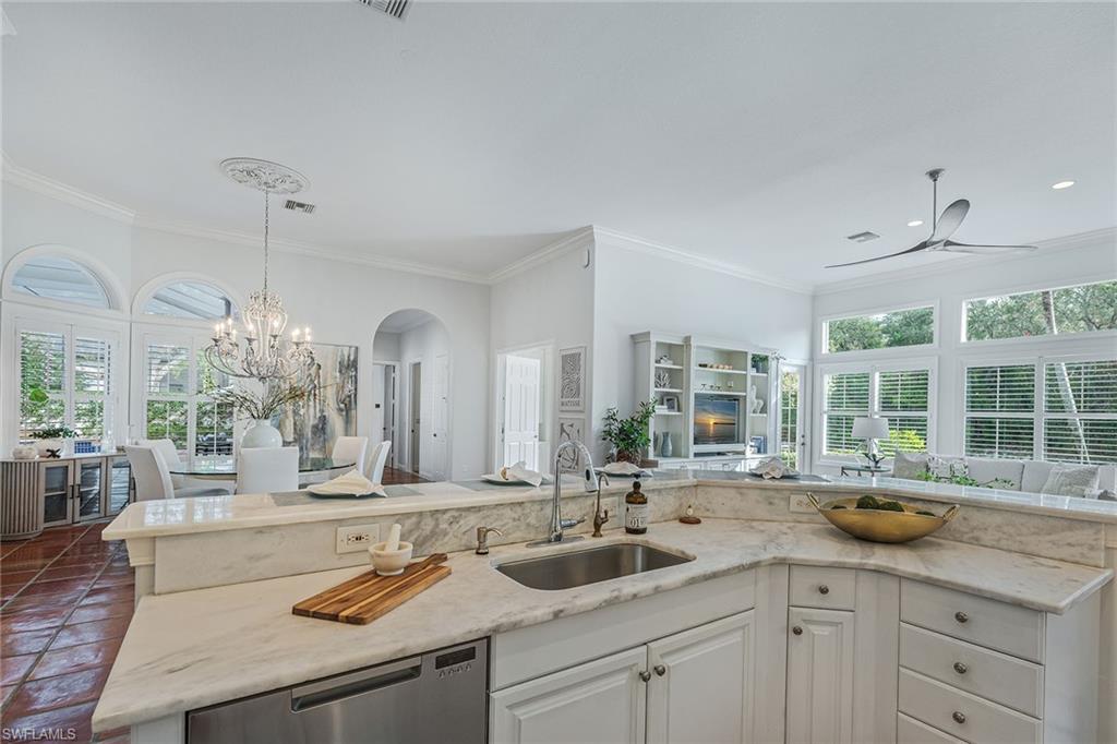 6648 Glen Arbor Way Naples, FL 34119 - Photo 15 of 47 a kitchen with counter a sink and cabinets