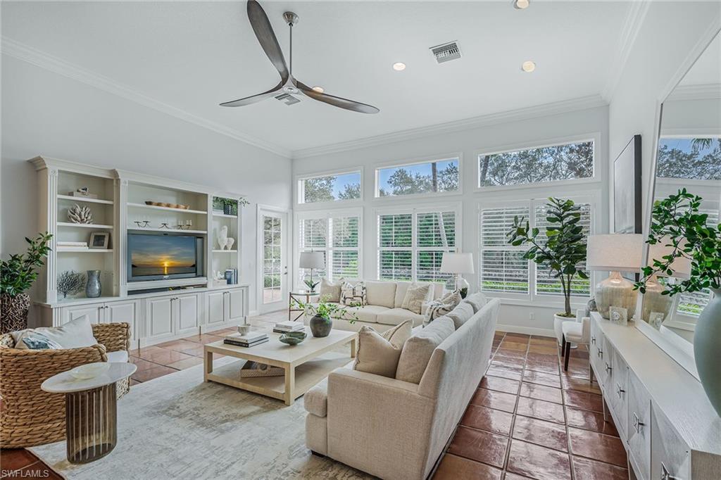 6648 Glen Arbor Way Naples, FL 34119 - Photo 17 of 47 a living room with furniture wooden floor and a flat screen tv