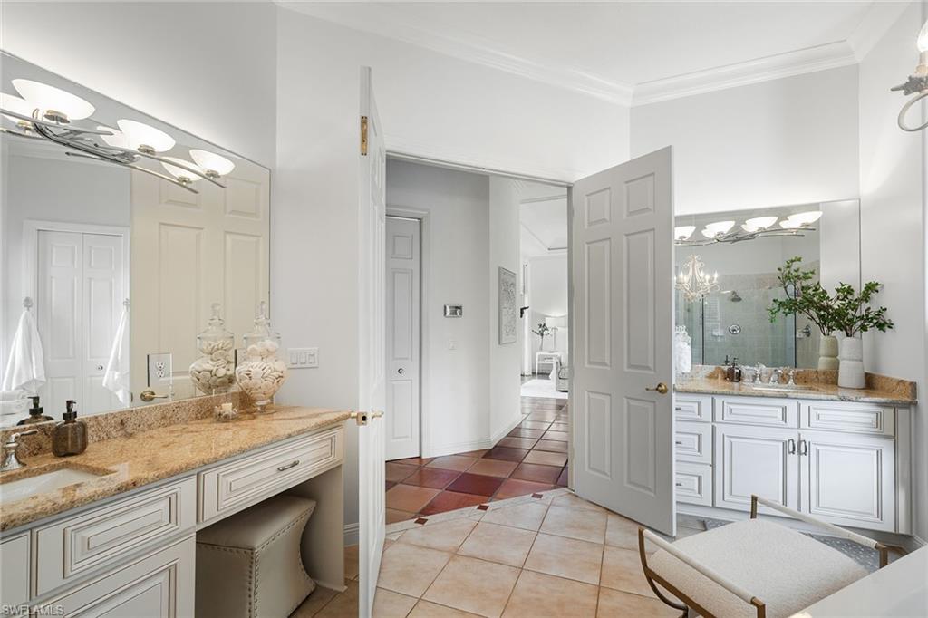 6648 Glen Arbor Way Naples, FL 34119 - Photo 27 of 47 a spacious bathroom with a granite countertop sink a toilet a mirror and shower