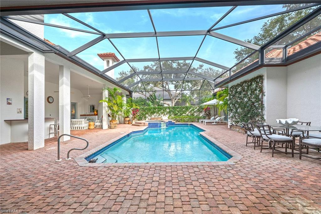 6648 Glen Arbor Way Naples, FL 34119 - Photo 30 of 47 a view of a swimming pool with outdoor seating