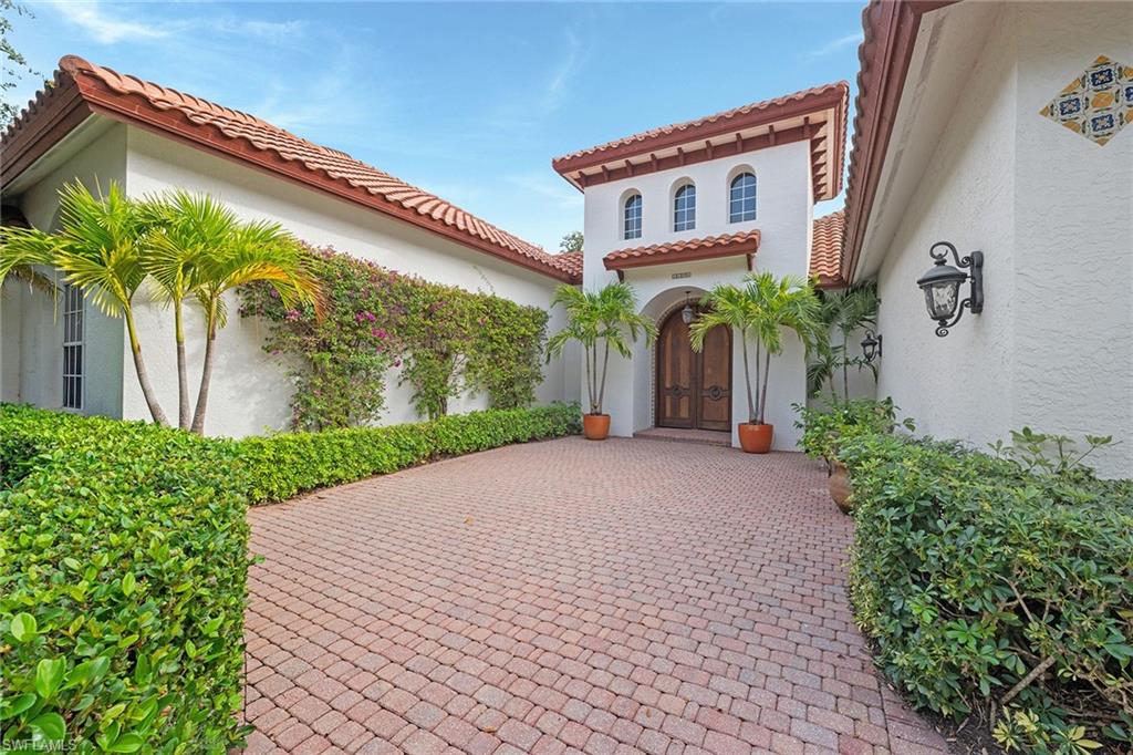 6648 Glen Arbor Way Naples, FL 34119 - Photo 3 of 47 a couple of potted plants in front of a house