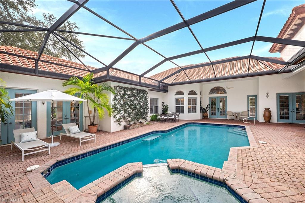 6648 Glen Arbor Way Naples, FL 34119 - Photo 32 of 47 a view of a swimming pool with a patio