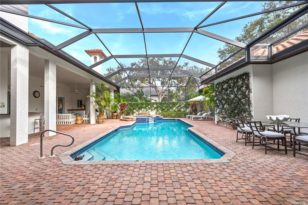 6648 Glen Arbor Way Naples, FL 34119 - Photo 34 of 47 a view of a swimming pool with outdoor seating