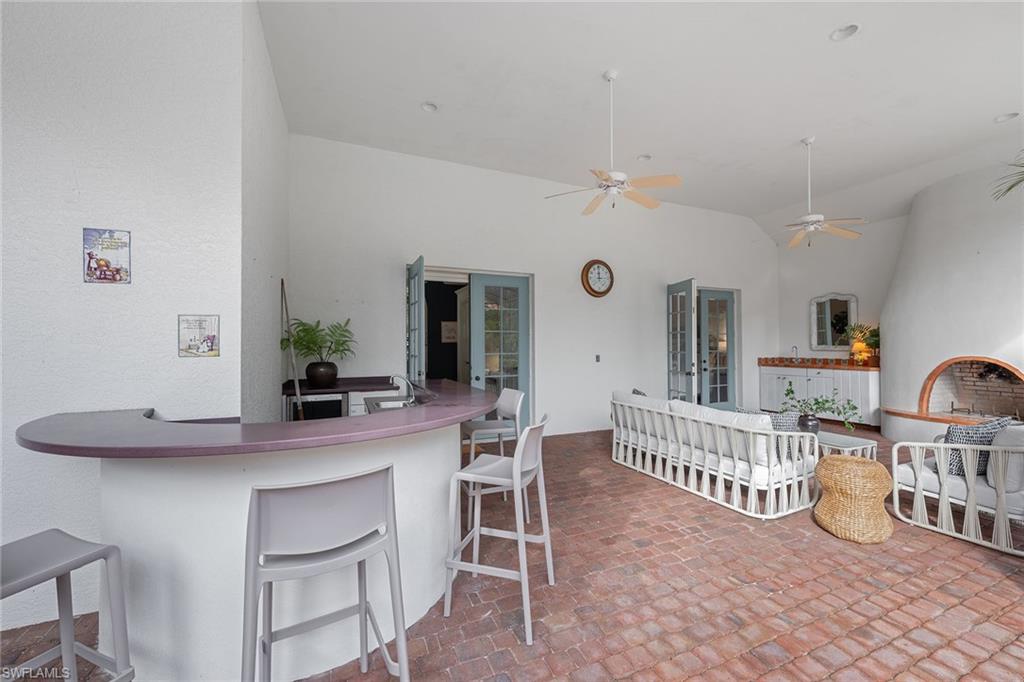 6648 Glen Arbor Way Naples, FL 34119 - Photo 38 of 47 a dining room with furniture and a dining table with projector