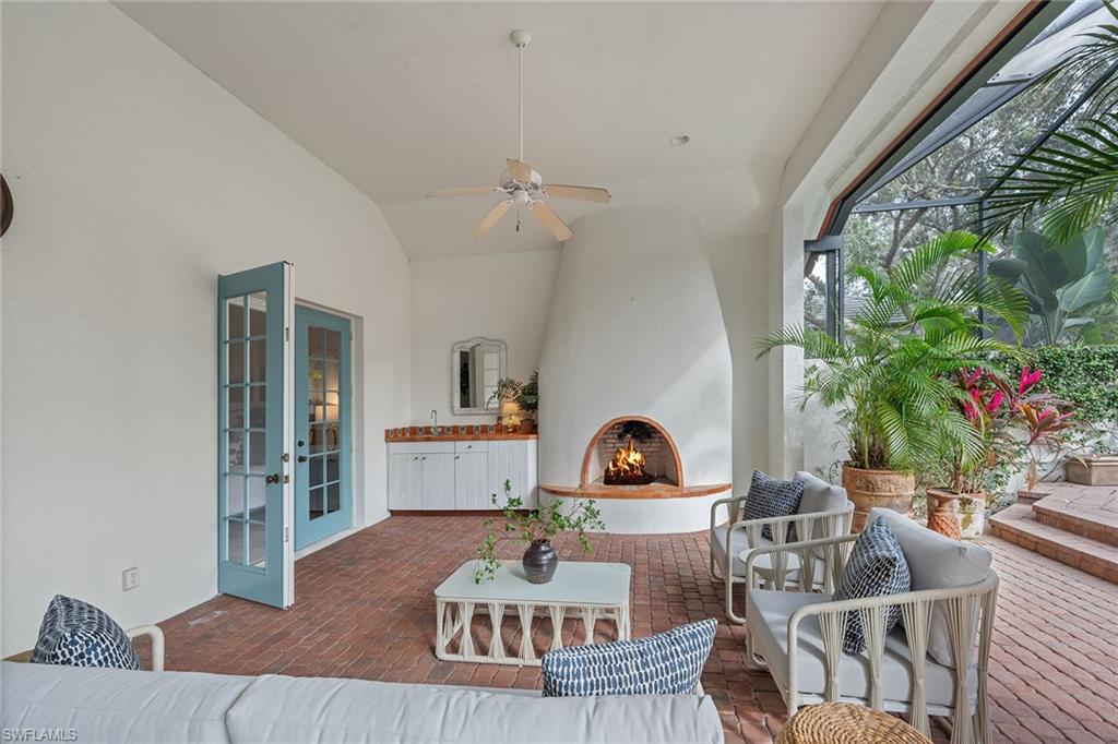 6648 Glen Arbor Way Naples, FL 34119 - Photo 39 of 47 a living room with furniture and a potted plant
