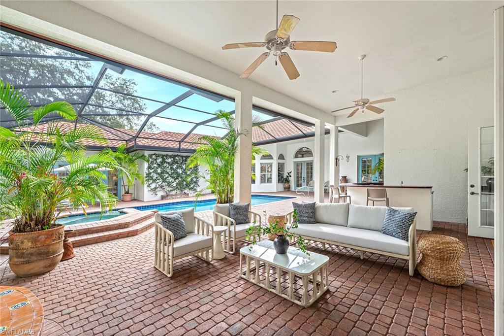 6648 Glen Arbor Way Naples, FL 34119 - Photo 40 of 47 a living room with furniture and a large window