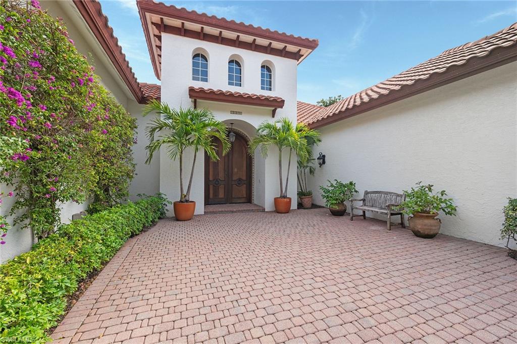 6648 Glen Arbor Way Naples, FL 34119 - Photo 4 of 47 a view of a house with potted plants and a large tree