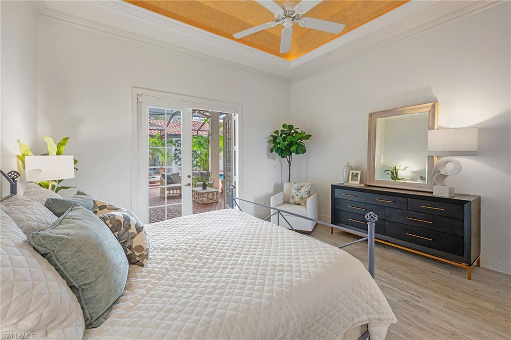 6648 Glen Arbor Way Naples, FL 34119 - Photo 43 of 47 a bedroom with a bed and ceiling fan
