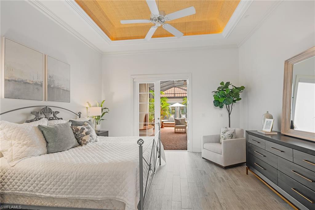 6648 Glen Arbor Way Naples, FL 34119 - Photo 45 of 47 a bedroom with a bed and a couch