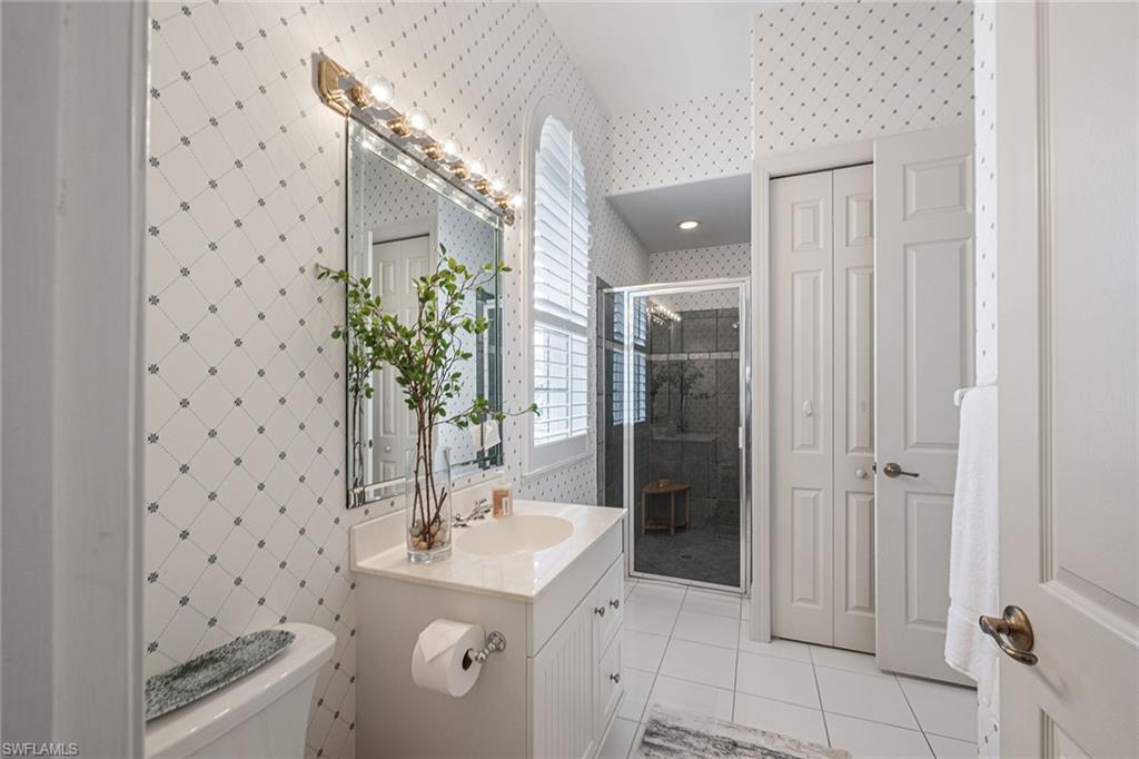 6648 Glen Arbor Way Naples, FL 34119 - Photo 46 of 47 a bathroom with a sink a toilet and shower