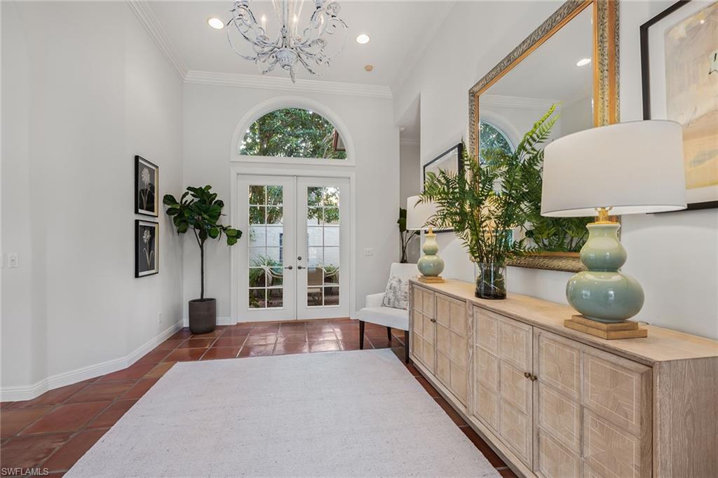 6648 Glen Arbor Way Naples, FL 34119 - Photo 5 of 47 a living room with furniture and a chandelier