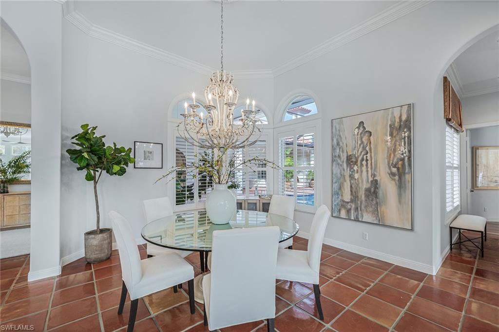 6648 Glen Arbor Way Naples, FL 34119 - Photo 9 of 47 a view of a dining room with furniture and chandelier