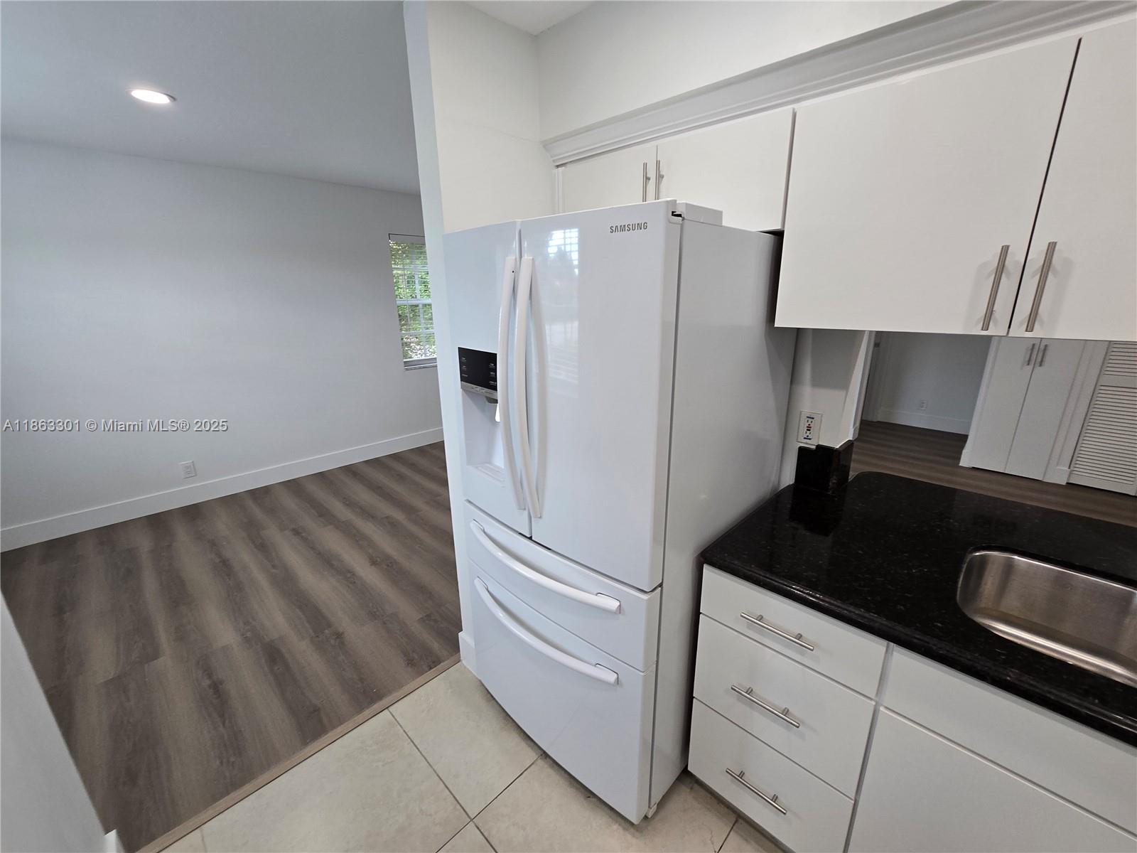 8886 Southwest 3rd Street, Unit 202 Pembroke Pines, FL 33025 - Photo 2 of 36 a kitchen with granite countertop a refrigerator and a sink