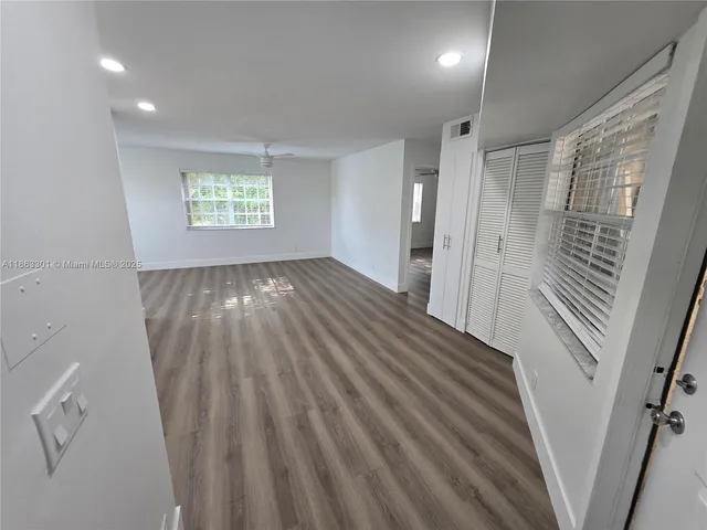 a view of a room with window and wooden floor