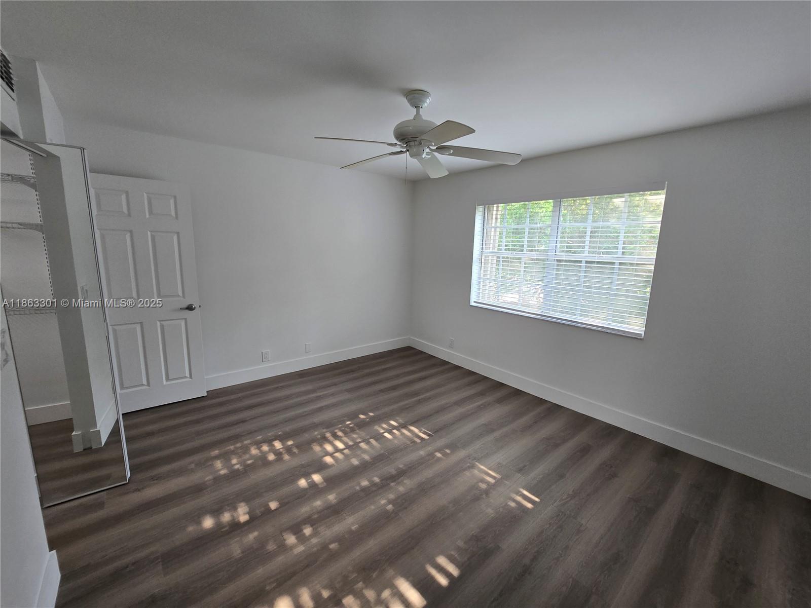 8886 Southwest 3rd Street, Unit 202 Pembroke Pines, FL 33025 - Photo 26 of 36 a view of an empty room with wooden floor and a window