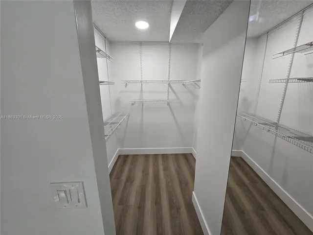 a view of a livingroom with wooden floor and a window