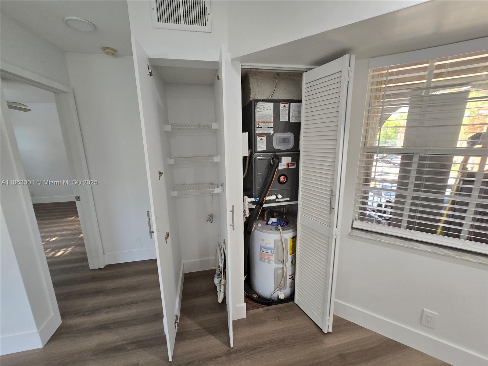 8886 Southwest 3rd Street, Unit 202 Pembroke Pines, FL 33025 - Photo 30 of 36 a view of a livingroom with wooden floor and a window
