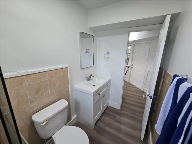 a white toilet sitting next to a bathroom sink