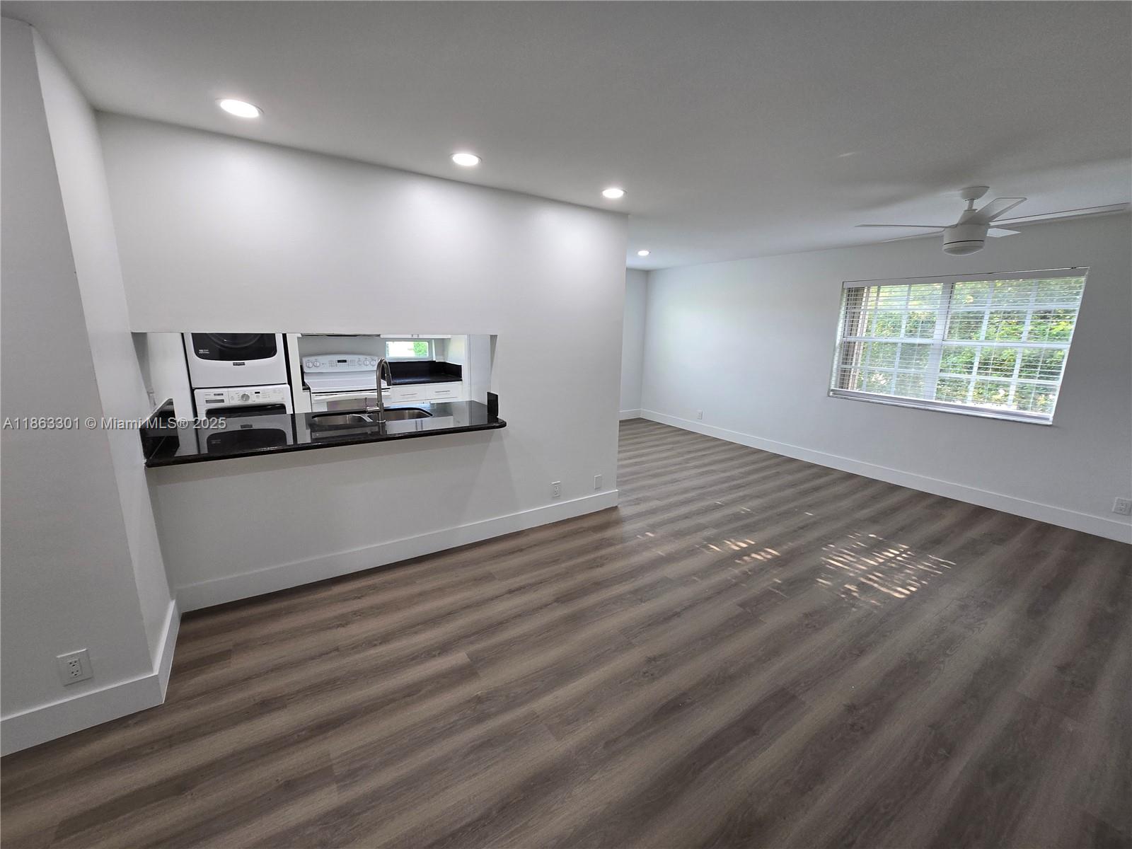 8886 Southwest 3rd Street, Unit 202 Pembroke Pines, FL 33025 - Photo 10 of 36 a view of a kitchen with stainless steel appliances wooden floor and a large window