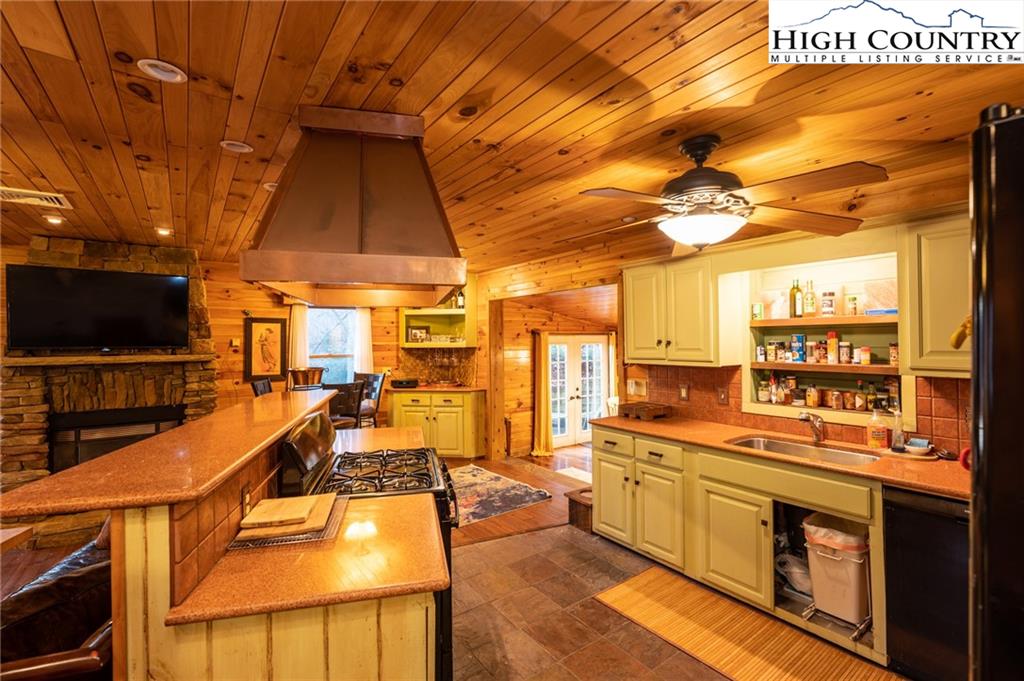 6218 Junaluska Road Boone, NC 28607 - Photo 13 of 33 a kitchen with stainless steel appliances kitchen island granite countertop a sink and cabinets